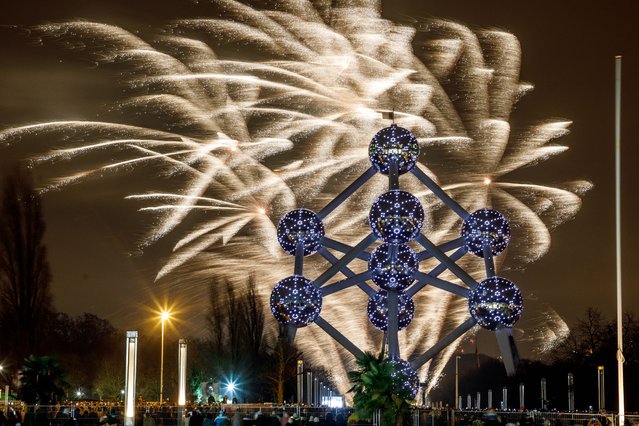 This photograph shows fireworks shoot at the Atomium in Brussels during the New Year's Eve celebration on early January 1, 2025. (Photo by Hatim Kaghat/Belga via AFP Photo)