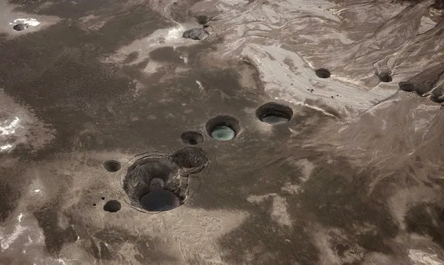 An aerial view of sinkholes created by the drying of the Dead Sea, near Kibbutz Ein Gedi, Israel, on November 10, 2011. (Photo by Menahem Kahana/AFP Photo via The Atlantic)