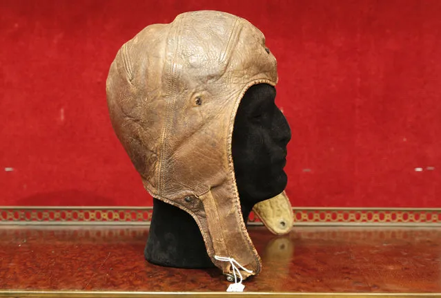 The leather cap of Captain Charles Lindbergh is pictured at the Drouot aucton house, Wednesday, November 16, 2016 in Paris. Lindbergh wore the aviation cap during his famous 33-hour transatlantic flight in 1927 from New York to Paris. Drouot's Wednesday sale is expected to fetch around $64 000-86 000. (Photo by Christophe Ena/AP Photo)