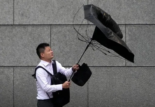 A pedestrian using an umbrella struggles against strong wind in Tokyo, Japan, 02 June 2023. Warm and humid air generated by Typhoon Mawar flowed into the rainy season front, causing increased activity and heavy rainfall mainly on the Pacific Ocean side. (Photo by Franck Robichon/EPA/EFE/Rex Features/Shutterstock)
