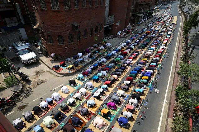 Muslims take part in Friday prayer as part of the holy fasting month of Ramadan on the street in front of a mosque amid the coronavirus disease (COVID-19) pandemic, in Dhaka, Bangladesh, April 16, 2021. (Photo by Mohammad Ponir Hossain/Reuters)