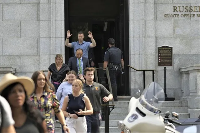 Government staffers walk out of the Russell Senate Office Building, Wednesday, August 2, 2023, on Capitol Hill in Washington. Authorities issued a shelter-in-place order and began searching Senate office buildings near the U.S. Capitol Wednesday afternoon amid reports of an active shooter. (Photo by J. Scott Applewhite/AP Photo)