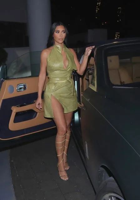 Kim Kardashian is all smiles as she parties with friends in Miami for the opening of the Goodtime Hotel in South Beach on April 17, 2021. Kim was spotted inside with owner David Grumman who she surprised for the event and then later headed to Papi Steak and her luxury hotel. She was in a custom Lamborghini and Rolls Royce with Jonathan Cheban and longtime friends Stephanie Sheppard and Simon Huck. The friends all had a laugh as they waited for their cars to head to the event. The 40-year-old reality TV bombshell, who is in the process of divorcing her third husband Kanye West, cut a typically glamorous figure on her latest night out. She slid her iconic hourglass frame into a glimmering golden peekaboo dress that showed off her cleavage to full advantage. (Photo by The Mega Agency)