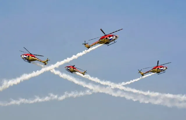 Indian Air Force (IAF) advanced light helicopters display team “Sarang” performs during the “Aero India 2015” air show at Yelahanka air base in Bengaluru February 19, 2015. (Photo by Abhishek N. Chinnappa/Reuters)