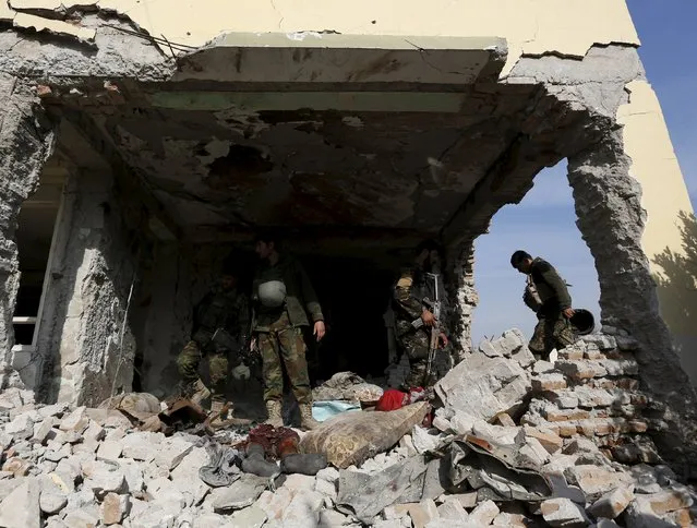 Afghan National Army (ANA) soldiers inspect a damaged building after a blast near the Pakistani consulate in Jalalabad, Afghanistan January 13, 2016. (Photo by Reuters/Parwiz)