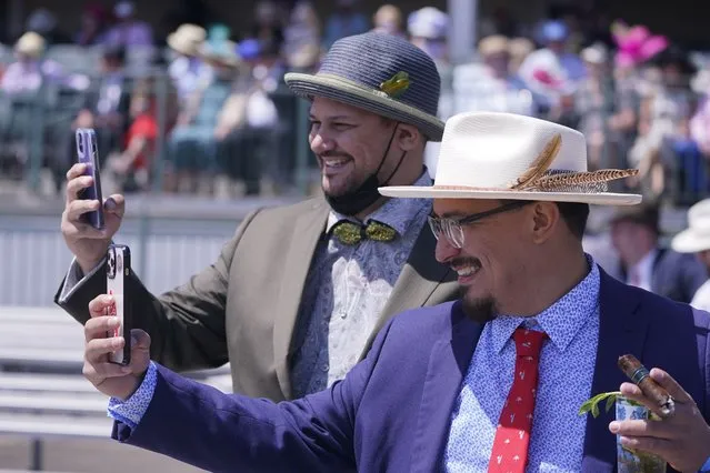 Men take photos of themselves before the 147th running of the Kentucky Derby at Churchill Downs, Saturday, May 1, 2021, in Louisville, Ky. (Photo by Charlie Riedel/AP Photo)