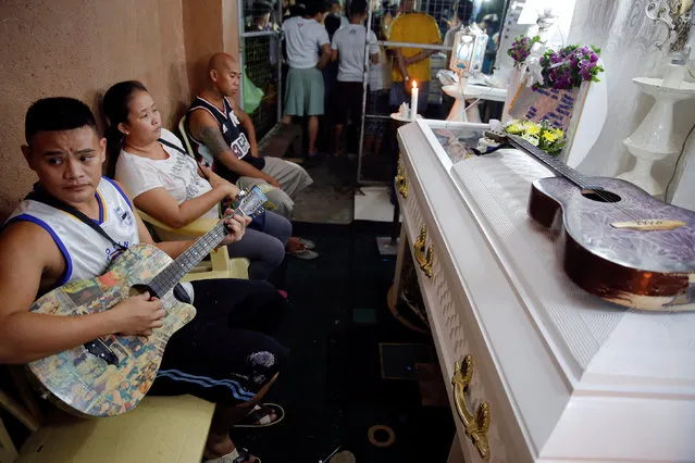 Friends and relatives of Florjohn Cruz, who was killed in a police drugs buy-bust operation, gather around his coffin during his wake in Manila, Philippines late October 20, 2016. (Photo by Damir Sagolj/Reuters)