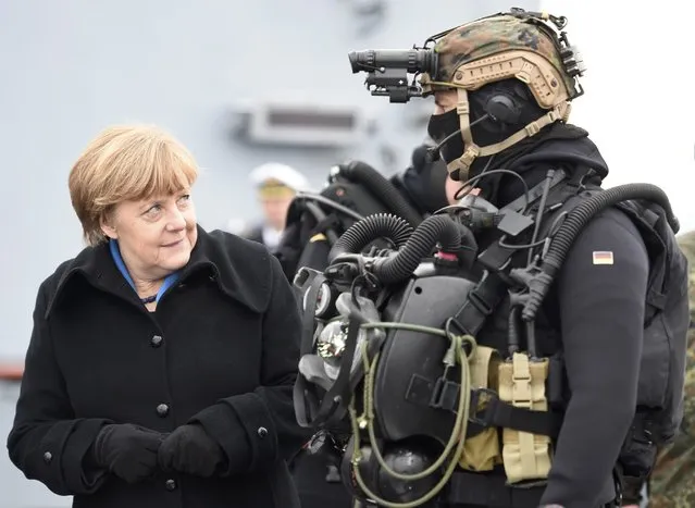 German Chancellor Angela Merkel looks at a combat diver during her visit to Naval Base Command in Kiel, Germany, January 19, 2016. (Photo by Fabian Bimmer/Reuters)
