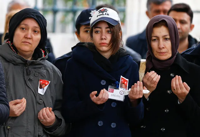 The daughter of police officer Hasim Usta who was killed in Saturday's blasts (C), prays during a funeral ceremony in Istanbul, Turkey, December 12, 2016. (Photo by Osman Orsal/Reuters)