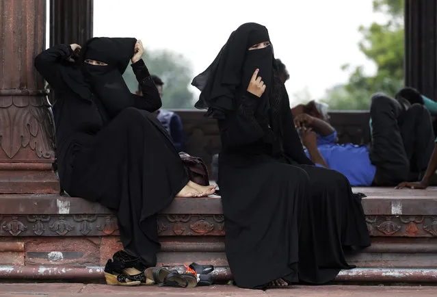 In this August 22, 2017 file photo, Indian Muslim women rest inside Jama Masjid mosque in New Delhi, India. India's government on Wednesday, Sept. 19, 2018, approved an ordinance to implement a top court ruling striking down the Muslim practice that allows men to instantly divorce. The government decision came after it failed to get approval of Parliament a year after the court ruled that the practice of triple “talaq” violated the constitutional rights of Muslim women. (Photo by Tsering Topgyal/AP Photo)