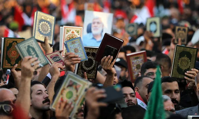 Iraqi demonstrators carry copies of the Koran and chant slogans during a protest near the Green Zone in Baghdad, Iraq, 22 July 2023. Hundreds of protesters on 22 July attempted to storm Baghdad's Green Zone, a heavily fortified area housing foreign embassies and Iraqi government offices, after a copy of the Koran had been allegedly burned the previous day in the Danish capital Copenhagen by an ultranationalist group. The incident came two days after demonstrators angered by the planned burning of the Islamic holy book in Sweden stormed the Swedish embassy in Baghdad. (Photo by Ahmed Jalil/EPA)