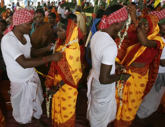 Tribal grooms and brides attend a mass marriage ceremony at Salbari village on the outskirts of Siliguri May 30, 2009. (Photo by Rupak De Chowdhuri/Reuters)