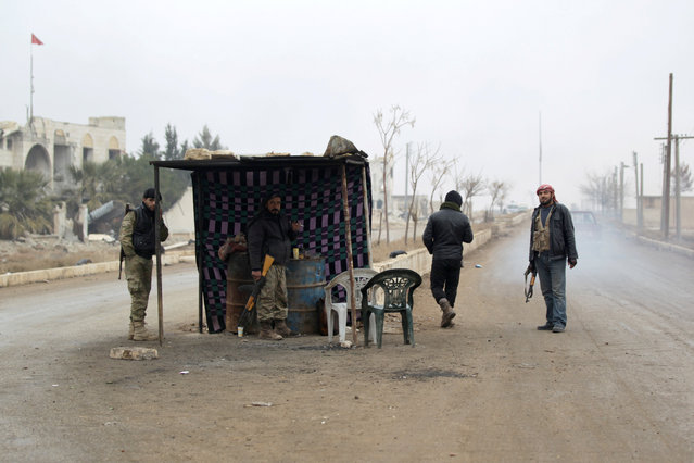 Rebel fighters man a checkpoint on an entrance to al-Rai town, northern Aleppo countryside, Syria December 25, 2016. (Photo by Khalil Ashawi/Reuters)