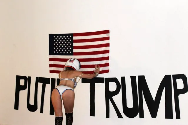 Nadeea Volianova the Russian Pop Star's bizarre, naked New Years “Art Installation” featuring an American flag, the named Putin and Trump in huge letters and the singer wearing a space helmet and not much else, Art Threat Gallery, Las Vegas, NV on December 29, 2016. (Photo by S_bukley/Splash News and Pictures)