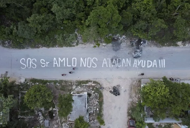 A phrase that reads in Spanish “SOS Mr. AMLO. We are being attacked. Help!!!” covers a street in the October 2 squatter settlement in Tulum, Quintana Roo state, Mexico, Thursday, August 4, 2022. The message was written by the squatters, directed at Mexican President Andres Manuel Lopez Obrador after local authorities attempted to evict them from a stretch of public land that was sold by city officials to largely foreign developers. (Photo by Eduardo Verdugo/AP Photo)