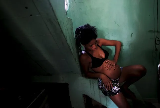 Tainara Lourenco, 21, who is five months pregnant, sits on the stairs inside the house of a relative in a slum of Recife, Brazil, February 7, 2016. The Zika virus, linked to thousands of birth defects in Brazil, is primarily transmitted through mosquito bites, but word surfaced this week of infections through s*x and blood transfusions. (Photo by Nacho Doce/Reuters)