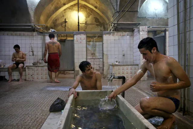 In this January 9, 2015 photo, two young laborers bathe at the Ghebleh public bathhouse, in Tehran, Iran. (Photo by Ebrahim Noroozi/AP Photo)