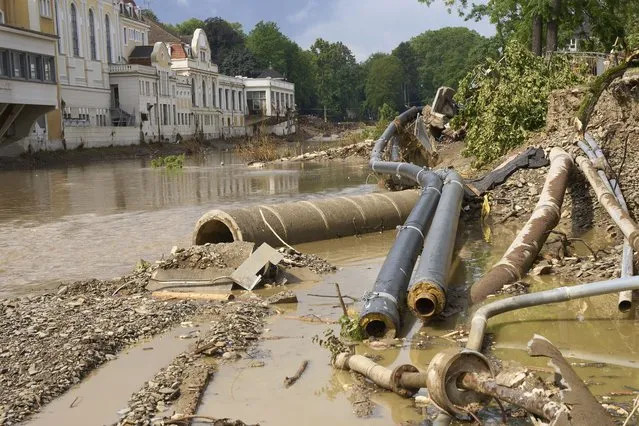 Washed away supply lines lies on the bank of the  river Ahr in front of the Kurhaus in Bad Neuenahr-Ahrweiler, Germany, Monday, August 2, 2021. The flood destroyed large parts of the infrastructure in the Ahr valley. Two and a half weeks after the flood disaster, the clean-up work is in full swing. (Photo by Thomas Frey/dpa via AP Photo