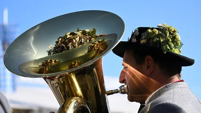 A brass musician plays his instrument during the the last day of the Oktoberfest beer festival in Munich, southern Germany, on October 3, 2023. (Photo by Christof Stache/AFP Photo)