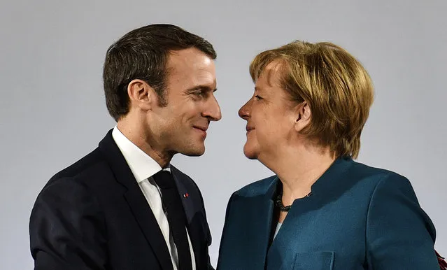 German Chancellor Angela Merkel watches French President Emmanuel Macron after the signing of a new Germany-France friendship treaty at the historic Town Hall in Aachen, Germany, Tuesday, January 22, 2019. The new Treaty of Aachen is the succession of the 1963 Elysee Treaty signed by West German Chancellor Konrad Adenauer and the then French President Charles de Gaulle. (Photo by Martin Meissner/AP Photo)