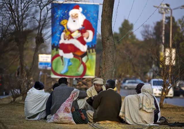 Pakistani Christians play cards on a roadside near their neighborhood ahead of Christmas in Islamabad, Pakistan, Tuesday, December 24, 2013. Christians are a minority in Pakistan, they constitute about 1.6% of the Pakistan's population. (Photo by B. K. Bangash/AP Photo)