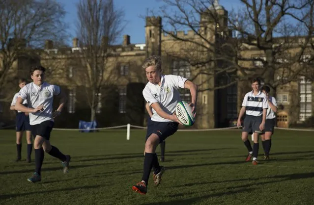A pupil runs with the ball as he takes part in rugby practice on the playing fields of Rugby School in central England, January 20, 2015. (Photo by Neil Hall/Reuters)