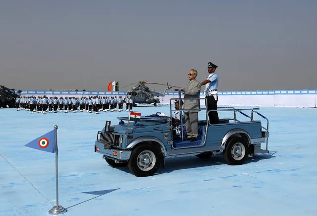 Indian President Pranab Mukherjee (front) watches as the Air warrior drill team perform during the President's Standard Presentation (PSP) held at Jamnagar Air Force Station in the western state of Gujarat, India March 4, 2016. (Photo by Amit Dave/Reuters)