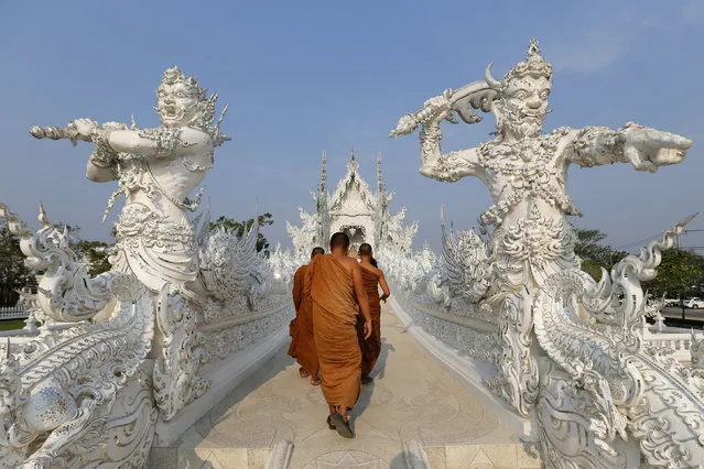 Buddhist monks take a tour at Wat Rong Khun also know as the White Temple designed by Thai visual artist Chalermchai Kositpipat in Chiang Rai Province, Thailand March 4, 2016. (Photo by Jorge Silva/Reuters)