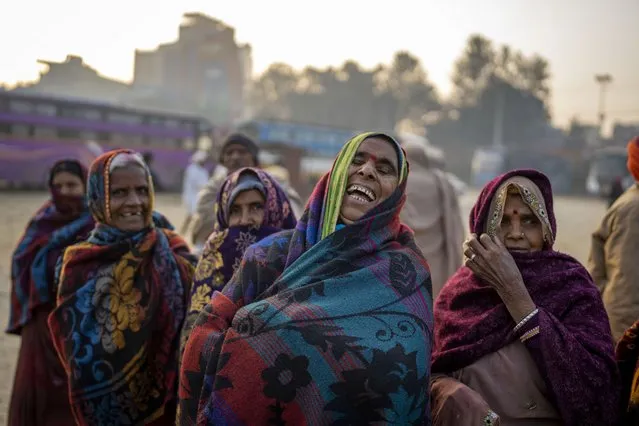 Indian pilgrims who have embarked on a visit to the sacred Pashupatinath temple react to being photographed in Kathmandu, Nepal, January 9, 2024. (Photo by Niranjan Shrestha/AP Photo)