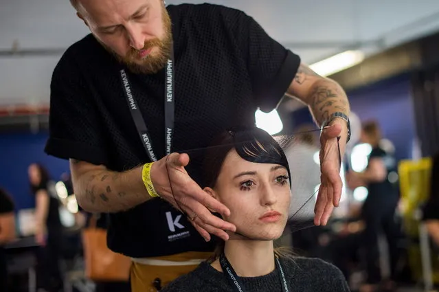 A model has her haircut done backstage during a show of the third bi-annual Budapest Central European Fashion Week in Budapest, Hungary, 30 March 2019. (Photo by Zoltan Balogh/EPA/EFE)