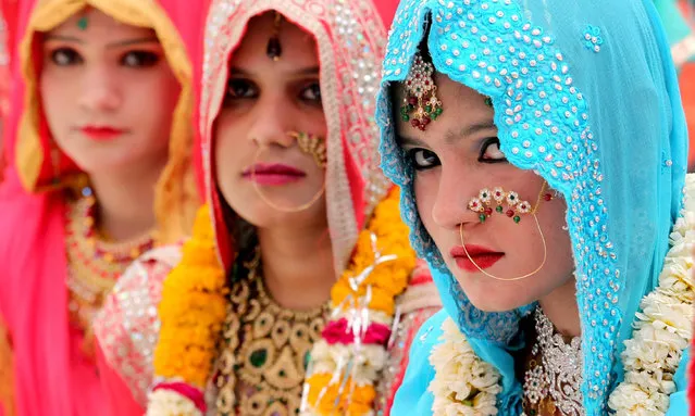 Muslim brides take part in a mass marriage ceremony under Mukhyamantri Kanyadan Yojna (chief minister welfare scheme) organized by the Zenith Muslim Educational and Social Welfare Society in Bhopal, India, 20 March 2016. More than 71 Muslim couples tied up the nuptial knot in the mass marriage ceremony. Some communities undertake the responsibility of arranging mass marriages for couples belonging to the financially weaker caste of the society. (Photo by Sanjeev Gupta/EPA)