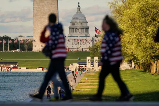 Tourists dressed in jackets with the flag of the United States on them walk past the U.S. Capitol in Washington, U.S., April 15, 2019. (Photo by Joshua Roberts/Reuters)