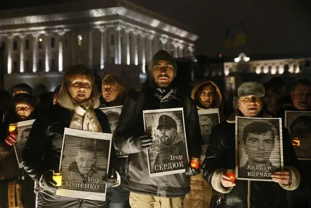 People hold portraits of anti-government protesters killed during the Ukrainian pro-European Union (EU) mass protests in 2014, as they commemorate the third anniversary of protests, in central Kiev, Ukraine February 20, 2017. (Photo by Valentyn Ogirenko/Reuters)