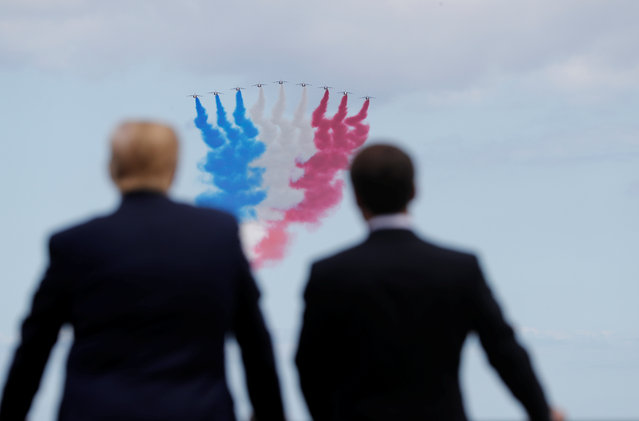 U.S President Donald Trump and French President Emmanuel Macron look to flypasts in the Normandy American Cemetery to commemorate the 75th anniversary of the D-Day landings, Normandy, France,  June 6, 2019. (Photo by Carlos Barria/Reuters)