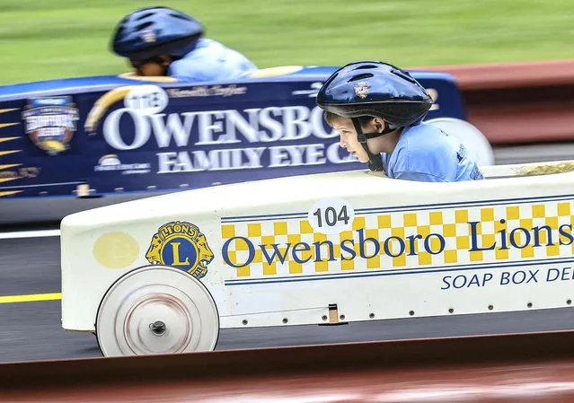 Simon Hamilton, 8, foreground, of Philpot, Ky, competes with Zack Gordon of Owensboro, Ky, as they make their way down the Ben Hawes Park Gravity Racing Track during the Owensboro Lions Club Soap Box Derby, Saturday, June 8, 2019, in Owensboro, Ky. (Photo by Greg Eans/The Messenger-Inquirer via AP Photo)