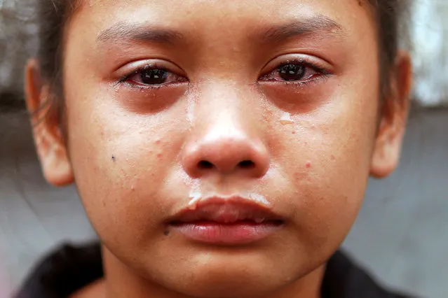 Kasandra Kate, 12, cries over the open coffin of her father Verigilio Mirano during his funeral at Navotas Public Cemetery in Manila, Philippines October 14, 2016. According to a family member, Mirano, who was using drugs but stopped after Rodrigo Duterte became the president, was killed by masked gunmen at his home on September 27th. (Photo by Damir Sagolj/Reuters)