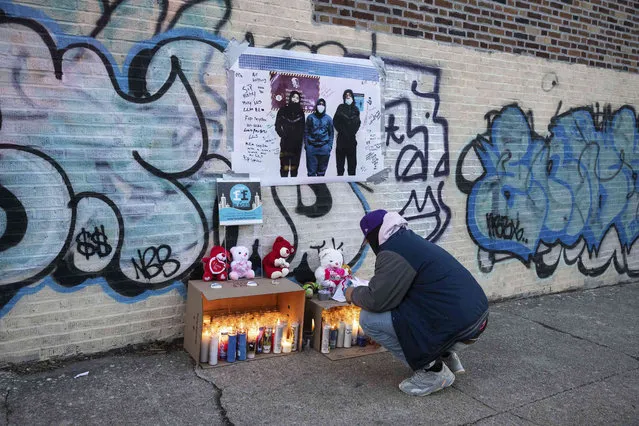 A person looks at the makeshift memorial for victims of the apartment building which suffered the city's deadliest fire in three decades, in the Bronx borough of New York on Wednesday, January 12, 2022. (Photo by Yuki Iwamura/AP Photo)