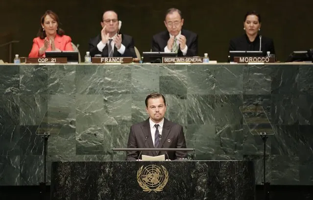 Actor Leonardo Di Caprio, a United Nations Messenger of Peace, speaks at the signing ceremony for the Paris Agreement on climate change, Friday, April 22, 2016 at U.N. headquarters. Behind him French President Francois Hollande, second left, and Secretary General Ban Ki-moon applaud. (Photo by Mark Lennihan/AP Photo)