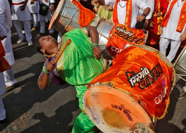 A woman dressed in traditional costume plays a drum as she attends celebrations to mark the Gudi Padwa festival, the beginning of the New Year for Maharashtrians, in Mumbai, India March 28, 2017. (Photo by Shailesh Andrade/Reuters)
