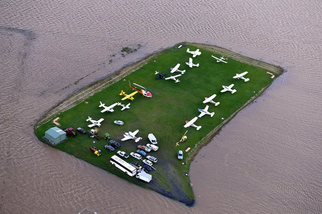 Aircraft can be seen surrounded by floodwaters near the airport of the northern New South Wales town of Lismore, Australia, March 31, 2017 after heavy rains associated with Cyclone Debbie swelled rivers to record heights across the region. (Photo by Dave Hunt/Reuters/AAP)