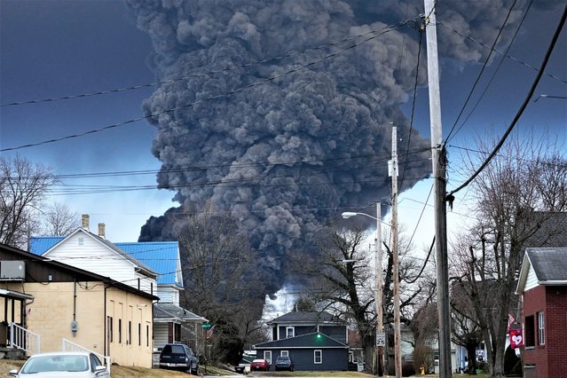 A black plume rises over East Palestine, Ohio, as a result of a controlled detonation of a portion of the derailed Norfolk and Southern trains Monday, February 6, 2023. (Photo by Gene J. Puskar/AP Photo)