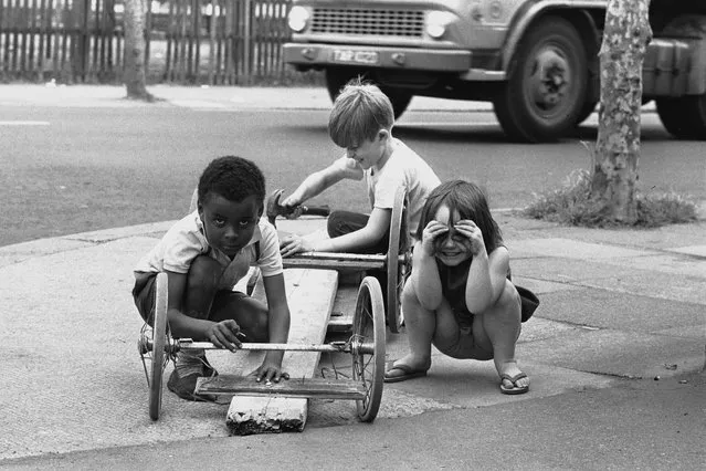 Three children build themselves a go-cart in the East End of London, 1960s. (Photo by Steve Lewis/Getty Images)