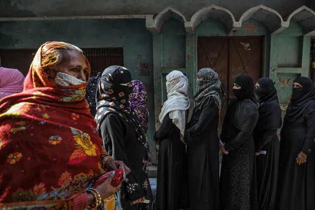 People queue to vote at a polling station during the fourth phase of state elections on February 23, 2022 in the old quarters of Lucknow, India. India's most populous state, Uttar Pradesh, is holding state elections in seven phases, as the Hindu-nationalist Bharatiya Janata Party (BJP) of Narendra Modi looks to defend its majority in its "cow belt" heartlands. The election is expected to be a barometer for the national political mood amid deepening sectarian divisions. (Photo by Ritesh Shukla/Getty Images)