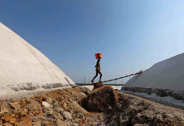 A labourer works on a salt pan on a hot summer afternoon in Mumbai, India, May 11, 2016. (Photo by Danish Siddiqui/Reuters)