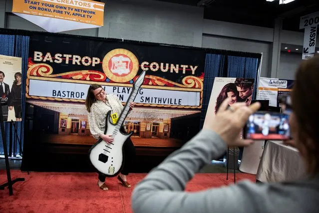 Bastrop County Community Impact Manager Candice Butts takes a photo during the Creative Industries Expo at the SXSW (South by Southwest) conference and festivals in Austin, Texas, U.S. March 14, 2022. (Photo by Montinique Monroe/Reuters)