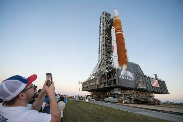 In this handout provided by the National Aeronautics and Space Administration (NASA), the Space Launch System (SLS) rocket with the Orion spacecraft aboard atop a mobile launcher as it rolls out of High Bay 3 of the Vehicle Assembly Building for the first time on its way to to Launch Complex 39B March 17, 2022 at Kennedy Space Center, Florida. Ahead of NASA's Artemis I flight test, the fully stacked and integrated SLS rocket and Orion spacecraft will undergo a wet dress rehearsal on the launch pad to verify systems and to practice countdown procedures for the first launch. (Photo by Aubrey Gemignani/NASA via Getty Images)