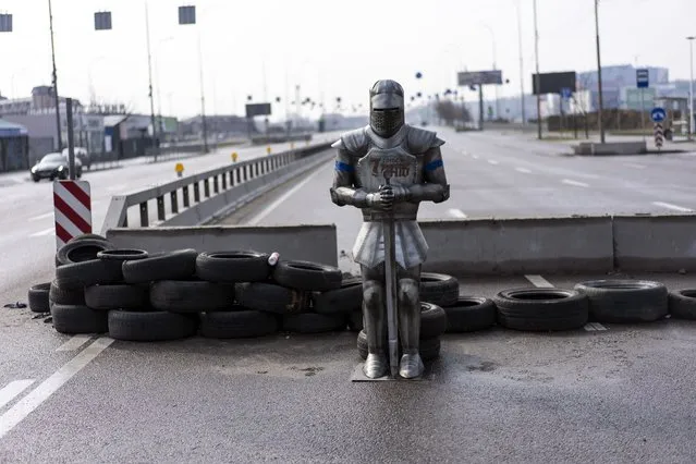 A medieval knight armor is displayed at a check point, on the outskirts of Kyiv, Ukraine, Thursday, March 31, 2022. (Photo by Rodrigo Abd/AP Photo)
