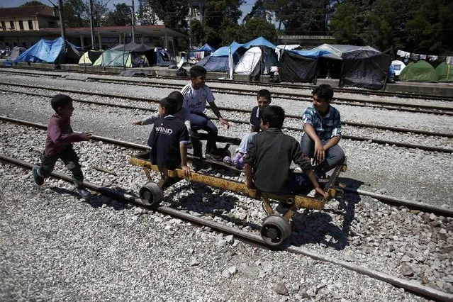 Syrian refugee children play with a wagonette at a makeshift camp for migrants and refugees at the Greek-Macedonian border near the village of Idomeni, Greece, May 23, 2016. (Photo by Kostas Tsironis/Reuters)