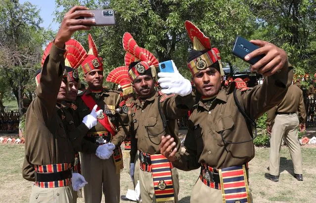 New recruits of the Indian Border Security Force (BSF) take selfie after passing out parade in Humhama, on the outskirts of Srinagar, the summer capital of Indian Kashmir, 04 April 2022. In total 242 recruits were formally inducted into the BSF after completing their training. Now they perform their duty in various parts of India. (Photo by Farooq Khan/EPA/EFE)