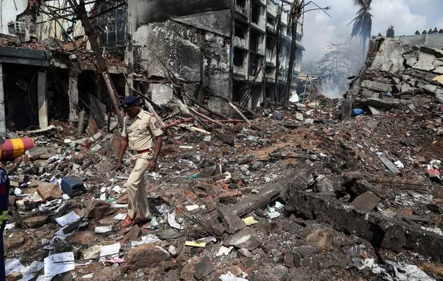 People inspect the damages after a blast in a chemical factory in Dombivali, on the outskirts of Mumbai, India, 26 May 2016. According to reports, at least three people were killed and 45 injured during a blast in a boiler unit. (Photo by Divyakant Solanki/EPA)